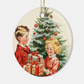 Boy and girl giving each other Christmas presents セラミックオーナメント (左)
