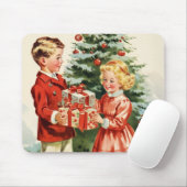 Boy and girl giving each other Christmas presents マウスパッド (マウス)