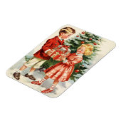 Boy and girl giving each other Christmas presents マグネット (左側)