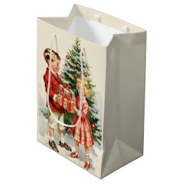 Boy and girl giving each other Christmas presents ミディアムペーパーバッグ