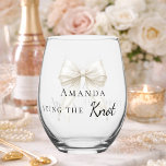 Bride tying the knot ivory bow Bachelorette ステムなしワイングラス<br><div class="desc">Celebrate in style with this elegant bachelorette party shot glass. The design features a delicate ivory, cream colored bow accented with pearls. It makes a perfect commemorative gift for the bride-to-be to use during her bridal shower or girls' night out.</div>