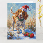 Brittany Spaniel Pointing at Santa's Glove Hat カード (黄色い花)