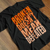 Broken Doesn’t Mean Defeated  Tシャツ