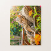 Cat sleeping in garden chair among flowers ジグソーパズル (縦)