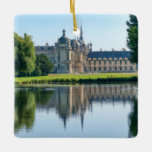 Chateau de Chantilly and reflection in a pond セラミックオーナメント<br><div class="desc">Rear view of the Chateau de Chantilly from the English Garden with reflection in a pond - France</div>