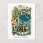 Christmas Village with Angels シーズンポストカード<br><div class="desc">Vintage Christmas card image of angels dressing a Christmas tree above a snow-covered village.</div>