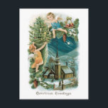 Christmas Village with Angels シーズンポストカード<br><div class="desc">Vintage Christmas card image of angels dressing a Christmas tree above a snow-covered village.</div>