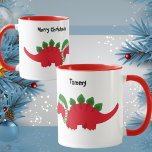 Cute Baby Stegosaurus with Colorful Christmas Hat マグカップ<br><div class="desc">This cute baby dinosaur mug with a custom message (Merry Christmas, Happy Holidays) and a custom name on the back, is the perfect gift! The inside of the mug is Bright Christmas Red, the handle is also Christmas red to add more Xmas cheer to your day. However, you can change...</div>