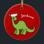 Cute Dinosaur Santa Claus Hat Red Kids Christmas セラミックオーナメント<br><div class="desc">Awesome green dinosaur smiling and looking very cute in a holiday red Santa hat. I like prehistoric Christmas animals and presents that kids will love. Customize this gift with the recipient's name to make it even more personalized.</div>