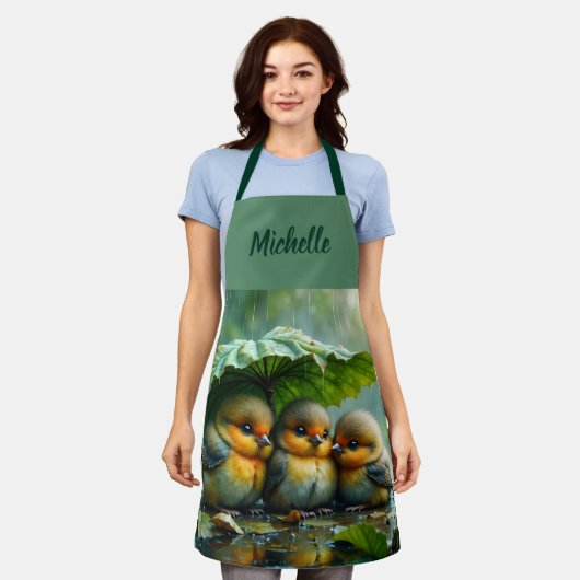 Cute fluffy birds hiding under leaf in rain エプロン (着用した状態)