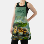 Cute fluffy birds hiding under leaf in rain エプロン (インサイチュ)