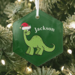 Cute Kids Christmas Dinosaur Green Personalized ガラスオーナメント<br><div class="desc">Awesome green dinosaur smiling and looking very cute in a holiday red Santa hat. I like prehistoric Christmas animals and presents that kids will love. Customize this gift with the recipient's name to make it even more personalized.</div>