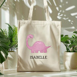 Cute Pink Dinosaur Personalized トートバッグ<br><div class="desc">This girls' tote bag features a cute illustration of a pink dinosaur with long eyelashes. Personalize it with your child's name in black letters. Makes a great book bag!</div>