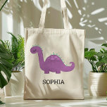 Cute Purple Dinosaur Personalized Tote Bag トートバッグ<br><div class="desc">This girls' tote bag features a cute illustration of a purple and green dinosaur with pink spots and long eyelashes. Personalize it with your child's name in black letters. Makes a great book bag!</div>