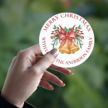 Cute Red Flowers Berries Bell Bow Merry Christmas ラウンドシール<br><div class="desc">Cute Red Flowers Berries Bell Bow Merry Christmas Classic Round Sticker . The sticker has a cute design with MERRY CHRISTMAS written in a pretty font with space to add family name. These cute stickers can be customized easily by changing the family name . For any further customization , feel...</div>