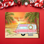 Cute RV Camper Warmest Wishes Beach Christmas シーズンポストカード<br><div class="desc">This Warmest Wishes holiday Christmas greeting card features a cute RV Camper at the beach. It is decorated with lights, a wreath and two pink Santa flamingo yard decorations. The camper is surrounded by palm trees with festive holiday lights and in the background the sun is setting (or rising) over...</div>