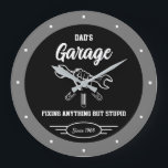 Dad's Any Name Garage Funny Slogan Hand Tools Fix ラージ壁時計<br><div class="desc">Any name garage with white hand and tools graphic on a black background with a light grey border. Just use the "personalize this template" option to change the text slogan or leave as is. Funny slogan typography with any date. Just choose the hand color and size.</div>