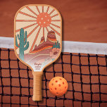 Desert Sunset Cactus Mesa Mountains Custom Text ピックルボールラケット<br><div class="desc">Play in style with this cool pickleball paddle featuring a retro vintage desert landscape design with a "pickleball sun", cactus, mesa mountains and flowers. Add 3 lines of custom text - name, monogram, pickleball club name, company name, location, phone number, etc. A perfect gift for adults, kids, moms, dads, or...</div>