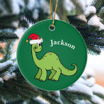 Dinosaur Christmas Cute Custom Kids Green セラミックオーナメント<br><div class="desc">Awesome green dinosaur smiling and looking very cute in a holiday red Santa Claus hat. Customize this adorable children's Christmas ornament gift with the recipient's name to make it even more personalized. Cool little boy present for a kid.</div>
