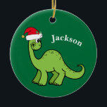 Dinosaur Christmas Cute Custom Kids Green セラミックオーナメント<br><div class="desc">Awesome green dinosaur smiling and looking very cute in a holiday red Santa Claus hat. Customize this adorable children's Christmas ornament gift with the recipient's name to make it even more personalized. Cool little boy present for a kid.</div>