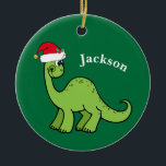 Dinosaur Christmas Cute Custom Kids Green セラミックオーナメント<br><div class="desc">Awesome green dinosaur smiling and looking very cute in a holiday red Santa Claus hat. Customize this adorable children's Christmas ornament gift with the recipient's name to make it even more personalized. Cool little boy present for a kid.</div>