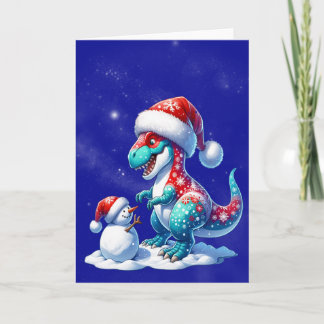 Dinosaur with santa hat building a snowman シーズンカード