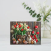 Easter bunny seated beside colorful eggs and tulip ポストカード (スタンド正面)