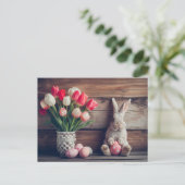 Easter bunny seated beside colorful eggs and tulip ポストカード (スタンド正面)