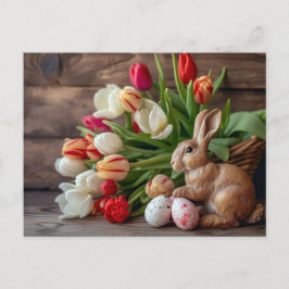 Easter bunny seated beside colorful eggs and tulip ポストカード