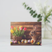 Easter bunny seated beside colorful eggs and tulip ポストカード (スタンド正面)