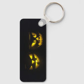 Eerie yellow glow pumpkin faces on black long キーホルダー (裏面)