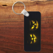 Eerie yellow glow pumpkin faces on black long キーホルダー (正面)