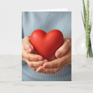 Elderly Woman Holding a Red Heart カード
