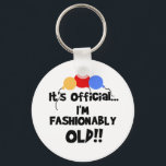 FASHIONABLY OLD キーホルダー<br><div class="desc">Three primary colors balloons and black text that reads "It's Official! I'm Fashionably Old!" on humorous birthday cards,  T-shirts,  mugs,  and more.</div>