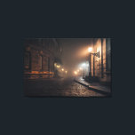 Foggy Victorian Cobblestone Alley Glow キャンバスプリント<br><div class="desc">Thick fog envelops a narrow Victorian cobblestone alley lit by warm amber street lamps mounted on elegant wrought-iron brackets. Tall Georgian brick buildings with tall windows rise on both sides, their details softened by the mist that turns every light into a glowing halo. The curving lane fades into impenetrable darkness,...</div>