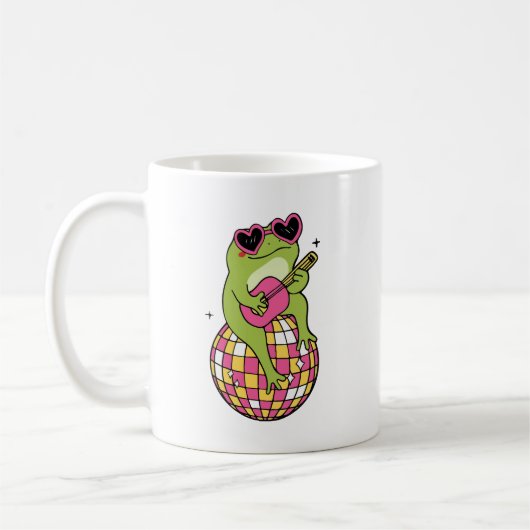 Frog sitting on dance ball playing guitar  コーヒーマグカップ (左)