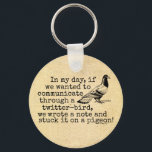 Funny Old Age Twitter Bird Pigeon キーホルダー<br><div class="desc">This funny saying / phrase design shows a homing pigeon being used as a carrier pigeon with a note on its leg. The antique, old-fashioned typewriter - style text reads, "In my day, if we wanted to communicate through a twitter-bird, we wrote a note and stuck it on a pigeon!"...</div>