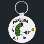 Funny Pickle Playing Pickleball キーホルダー<br><div class="desc">Wonderful artistic funny pickle wearing a blue cap and playing pickleball design makes a fun unique gift.  Can also add custom text and change background color when ordering.</div>