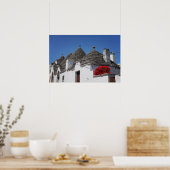 Geranium flowers and trulli houses in Alberobello ポスター (キッチン)