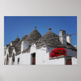 Geranium flowers and trulli houses in Alberobello ポスター