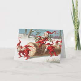 Gnomes dragging a cut tree trunk through the snow カード