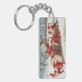 Gnomes dragging a cut tree trunk through the snow キーホルダー (正面左)