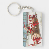 Gnomes dragging a cut tree trunk through the snow キーホルダー (正面)