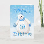 Godson's First Christmas Snowman シーズンカード<br><div class="desc">Cute little snowman wearing blue winter hat, scarf and mittens as delicate snowflakes fall through the winter sky is a delightful Christmas design for godson's first Christmas greeting card. Personalize the inside verse using the template provided. You may also enjoy matching snowmen designs on other cards and gifts available in...</div>