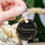 Gold Frills on Black Bridesmaid Wedding Gift キーホルダー<br><div class="desc">These keychains are designed to give as favors to bridesmaids in your wedding party. They feature a simple yet elegant design with a classic black background, gold script lettering, and a lacy golden faux foil floral border. The text says "Bridesmaid" with space for her name, the names of the couple,...</div>