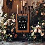Gothic Black Raven & Black Arch Rust Wedding テーブルナンバー<br><div class="desc">Transport your guests to a world of dark, enchanting elegance with our vintage gothic wedding table number card. The deep, aged burnt orange rust background sets the stage for a striking contrast, as bold white text emerges from intricate black text boxes. At the pinnacle of this invitation, a three-dimensional gothic...</div>