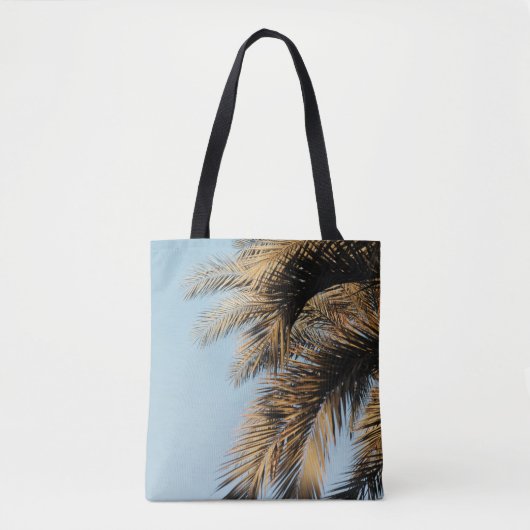 Green palm tree under blue sky in the morning トートバッグ (正面)