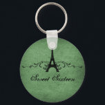 Green Vintage French Flourish Sweet 16 Keychain キーホルダー<br><div class="desc">Grungy yet elegant Vintage French Flourish Sweet Sixteen Keychain in dark green featuring an Eiffel Tower design embellished with chic swirls and dots and a faux paper textured background. This unique Parisian themed Sweet 16 keychain would be perfect for a french inspired party favor. Easy to customize, simply add the...</div>
