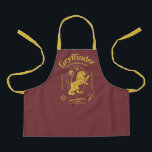 GRYFFINDOR™ Determination Courage Bravery Crest エプロン<br><div class="desc">Show your house pride with this bold Gryffindor™ crest design, celebrating the values that define the bravest of witches and wizards. Featuring the iconic lion standing proudly before a shield, this striking artwork highlights Gryffindor’s core traits — Courage, Determination, and Bravery — in a powerful, vintage-inspired layout. The rich house...</div>