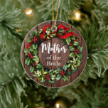 Holly Wreath Mother of the Bride Custom Wedding セラミックオーナメント<br><div class="desc">Holly Wreath "Mother of the Bride" Wedding Party Beautiful keepsake gift Christmas ornament, with custom text on back. Ornament in red and green holiday Christmas wreath and country rustic wood plank background! Add your personalized message on back as well. Vibrant and colorful beautiful keepsake wedding christmas ornament. Share the Holidays...</div>